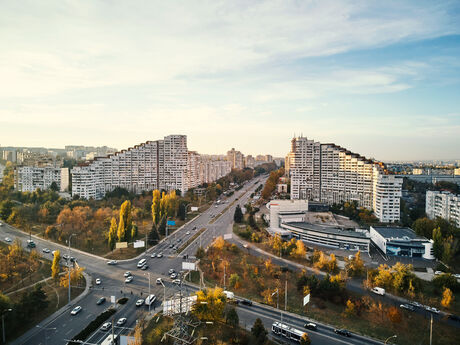 Aerial view of a large intersection with multiple lanes and surrounding residential buildings