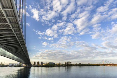 Panoramic photograph of Belgrade and Sava river with the Bridge Over Ada and the New Railroad bridge in the distance, made at dusk, from the lower tip of Ada Ciganlija river isle