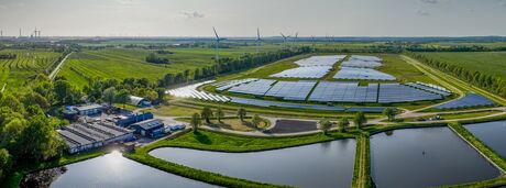 Environmentally friendly installation of photovoltaic power plant and wind turbine farm situated by landfill.Solar panels farm built on a waste dump and wind turbine farm. Renewable energy source