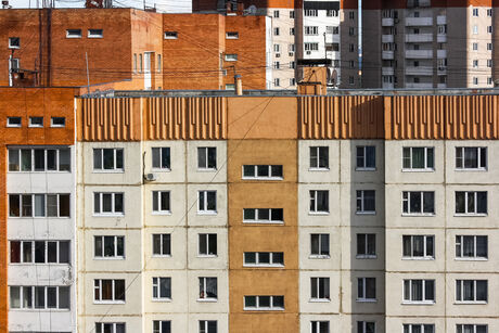 Facades of multi-story residential buildings with numerous windows and balconies